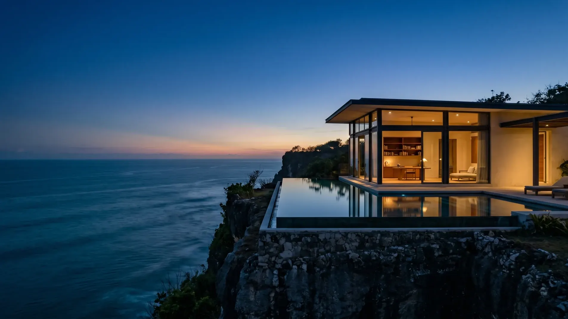 Modernist clifftop Bali villa at twilight on the Bukit peninsula above the Indian Ocean
