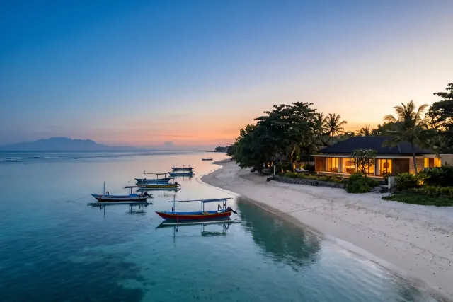 Sanur sunrise over the east-coast lagoon with traditional jukung outrigger boats