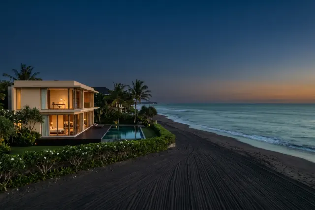 Seminyak beach at golden hour with elegant villa silhouettes